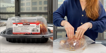 a woman looking at a box of meat