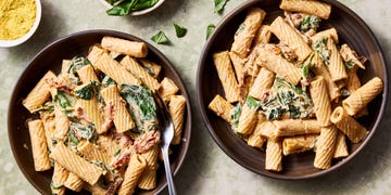 rigatoni tossed in a creamy vegan tuscan sauce with spinach and sundried tomatoes