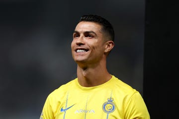 al nassr soccer player cristiano ronaldo looking up and smiling before a match