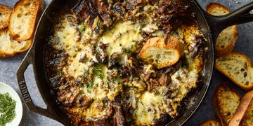 onion seasoned beef is nestled in a bed of cooked onions, red wine, fresh thyme, and beef broth, then braised until ridiculously tender, shredded, and topped with nutty, salty gruyere cheese