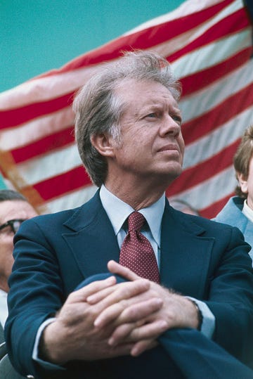 president jimmy carter seated near american flag