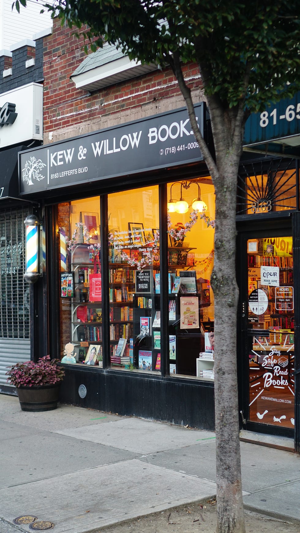 bookstore front with large windows displaying books and decor