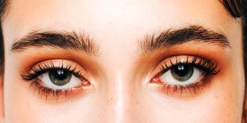 person with dark brown eyebrows and green eyes