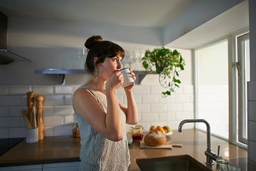 a woman standing in her kitchen