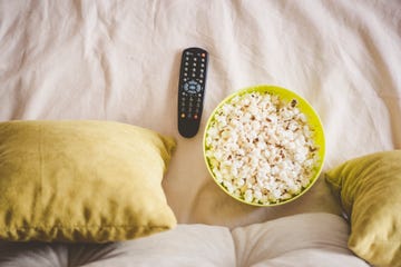 bowl of popcorn with tv remote control