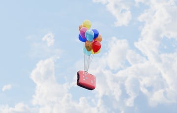 conceptual image of a red suitcase being lifted by balloons and flying away on a journey