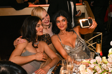 group of women enjoying a celebratory event taking a selfie at a dinner table