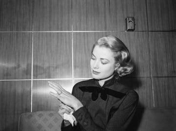 original caption 1101956 chicago, il film actress grace kelly, en route to hollywood for movie work, strikes a pose to show off the engagement ring given her by prince rainier iii of monico as she arrives in chicago ther princess to be posed amiably for photographers on her arrival by train from new york rainier will join her on the coast next month, and they will be wedd after her film commitments are completed