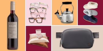 a collection of cozy items including wine glasses a kettle slippers and pillows