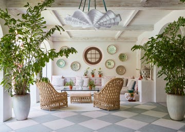 a room with a table chairs and plates