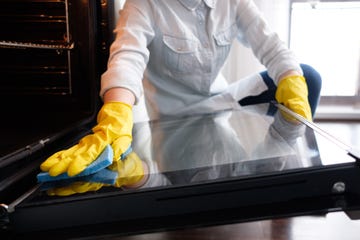 wiping inside of oven with sponge