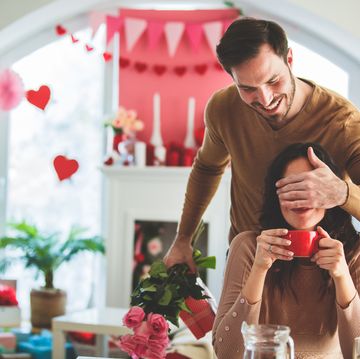 husband surprises wife on valentine's day with flower bouquet