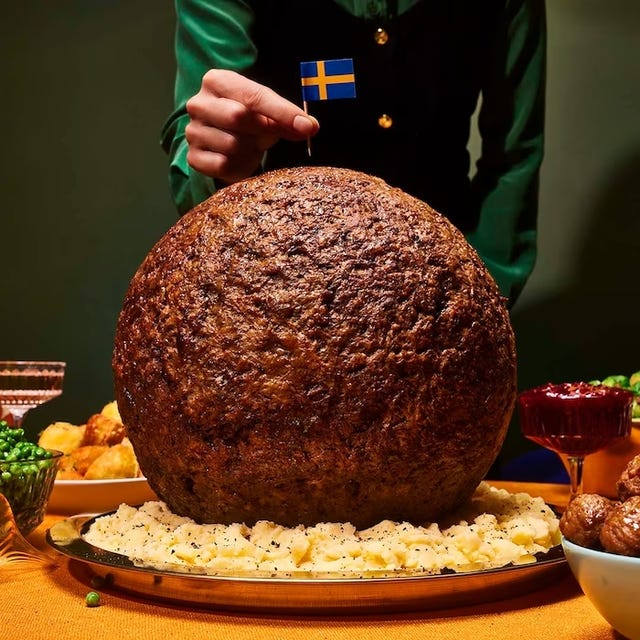 a person holding a large chocolate cake