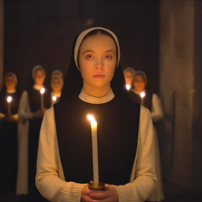 a person holding a lit candle