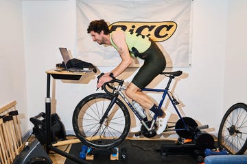 indoor cycling training setup featuring a cyclist on a stationary bike