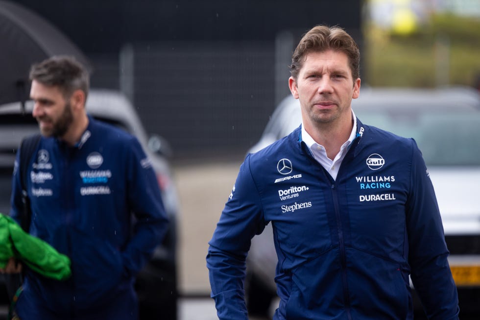 james vowles, in williams formula 1 team kit, walks from his parked car at a grand prix