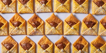 letter shaped pastries filled with chocolate and cinnamon sugar on a plate with milk