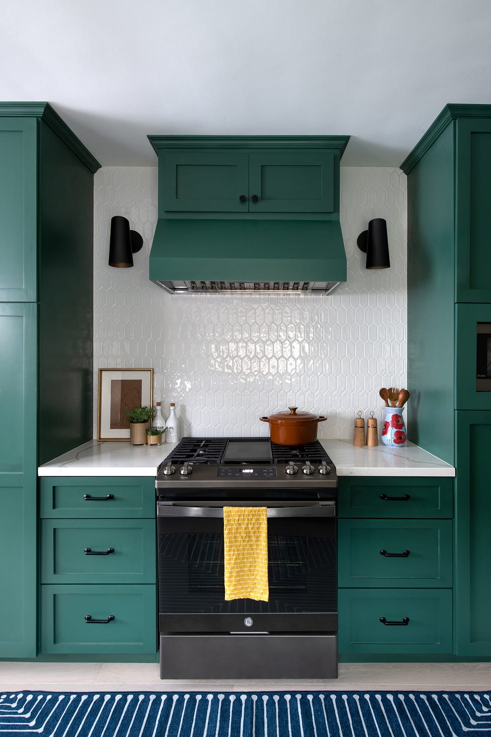 dark green cabinets with black hardware