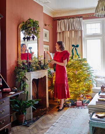 a festive living room with a decorated christmas tree a fireplace and holiday decorations