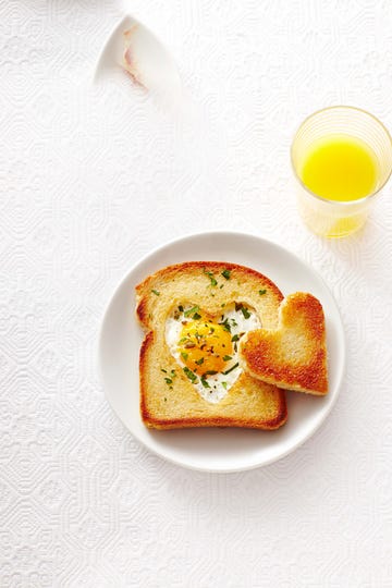 heart toast with egg in the middle on a white plate