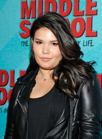 madison de la garza wears a leather jacket on a red carpet