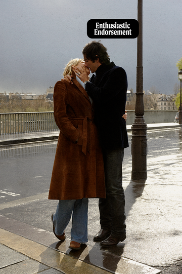 a man and woman kissing in the street