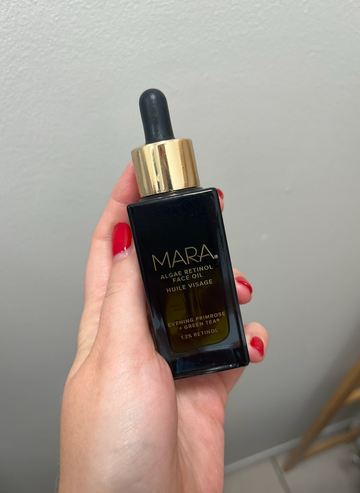 a bottle of mara algae retinol face oil being held in hand