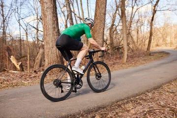 mature man cycling on rural road