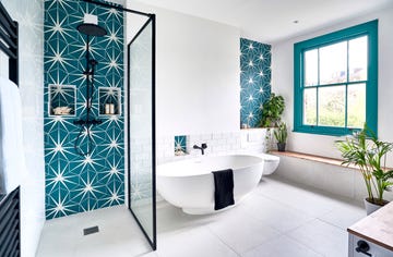 ripples bathroom makeover with freestanding white bath tub walk in shower and statement tiles