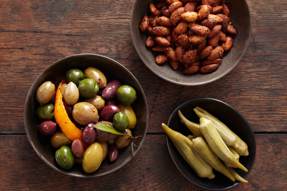 bowls of almonds, olives and pickled okra