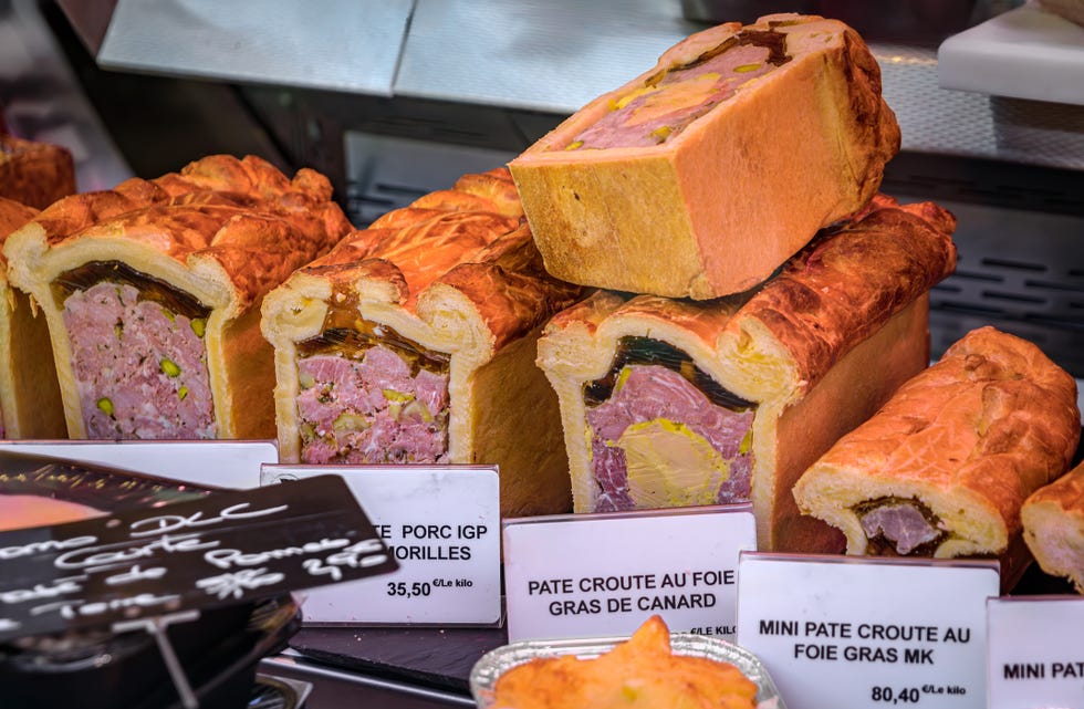 foie gras or duck liver pate in a pastry, meat pie at a market