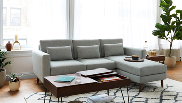 a living room with a couch and coffee table