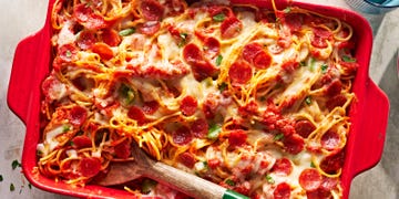 pizza spaghetti with cheese and pepperoni in a baking dish