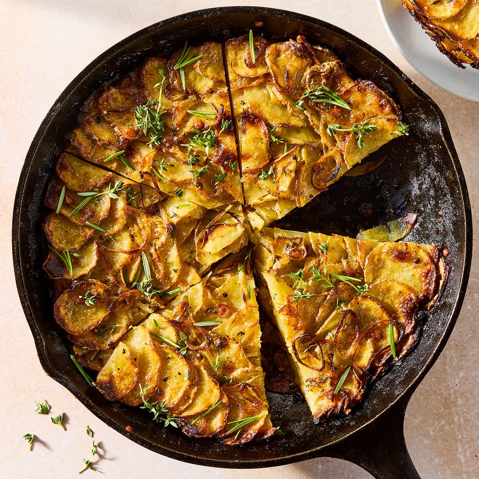 galette in a pan layered with thinly sliced potatoes