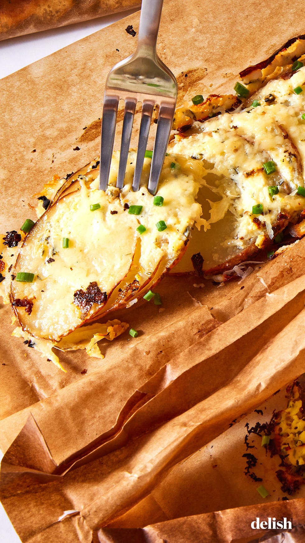 thinly sliced red potatoes layered with herby cream cheese, parmesan, and gruyere and baked in a parchment pouch