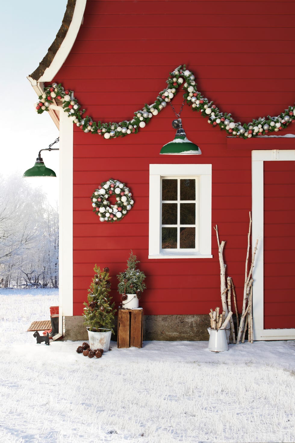 red house exterior with small trees planted in enamel buckets