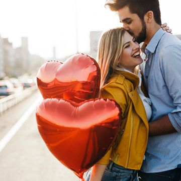 romantic young couple in love, hugging on the street