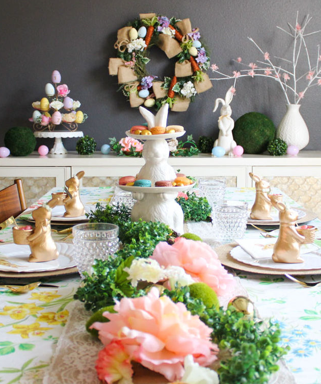 a table with flowers and statues