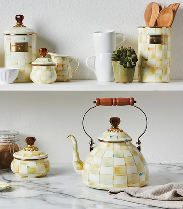 collection of kitchenware including a kettle sugar bowl and various containers