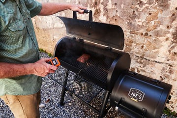 man using thermopro meat thermometer