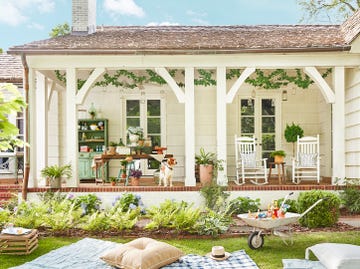 a dog sitting on a patio in front of a house in best backyard ideas