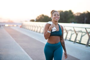 tattooed young woman going home after running in the morning