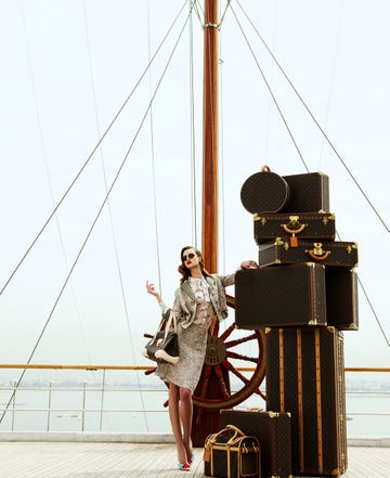 woman with lots of luggage on the deck of a ship