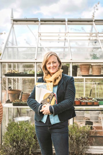 sally standing outside her greenhouse