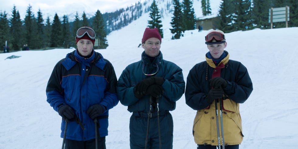 a group of people posing for a photo on a snowy mountain