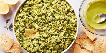 finely chopped green vegetables in a bowl with tortilla chips