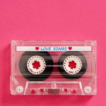 transparent audio cassette tape lying on pink background