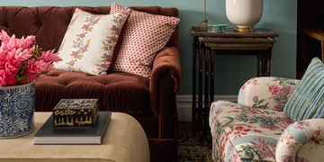 brown tufted sofa against blue wall