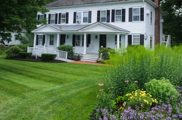 a white house with a big garden and a handicapped entrance 