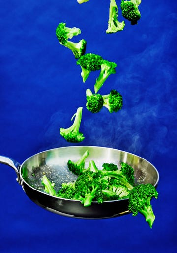 broccoli being tossed in a pan